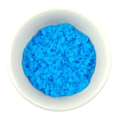 Photo of a blue powder in a white porcelain bowl